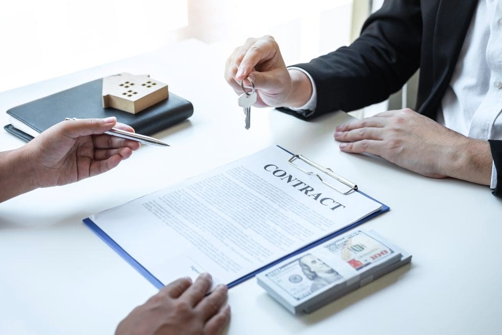 Understanding Due Diligence in a Real Estate Contract.  Real estate agent with buyer signing contract