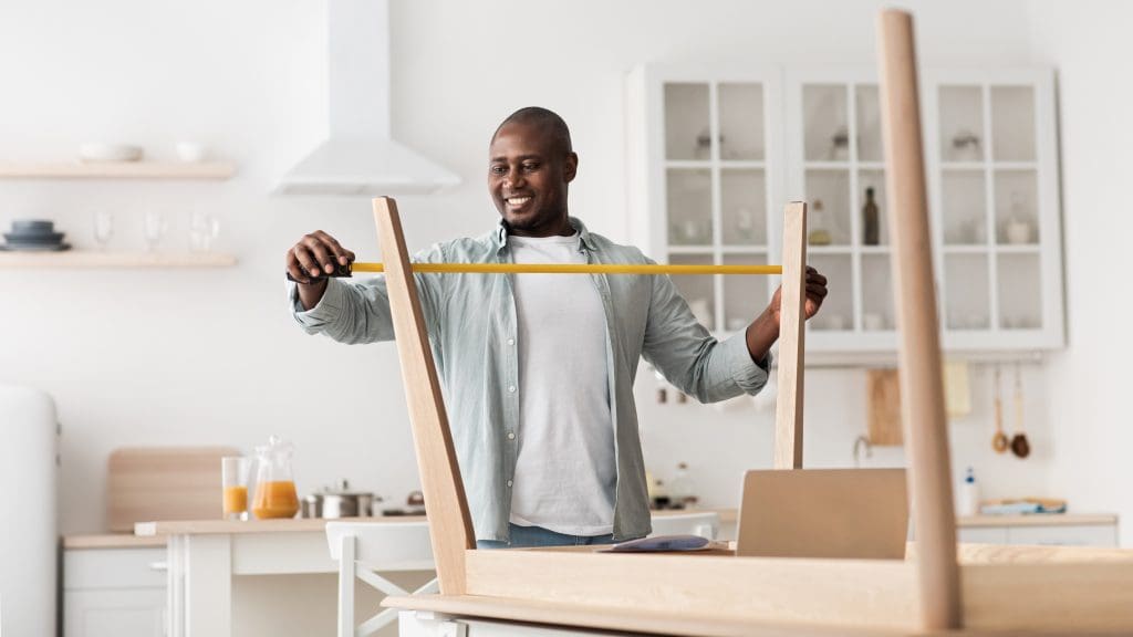 Man measuring furniture 