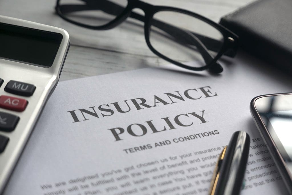 insurance policy, glasses, pen, homeowners insurance