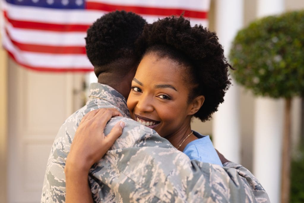 military-family-hugging-and-smiling