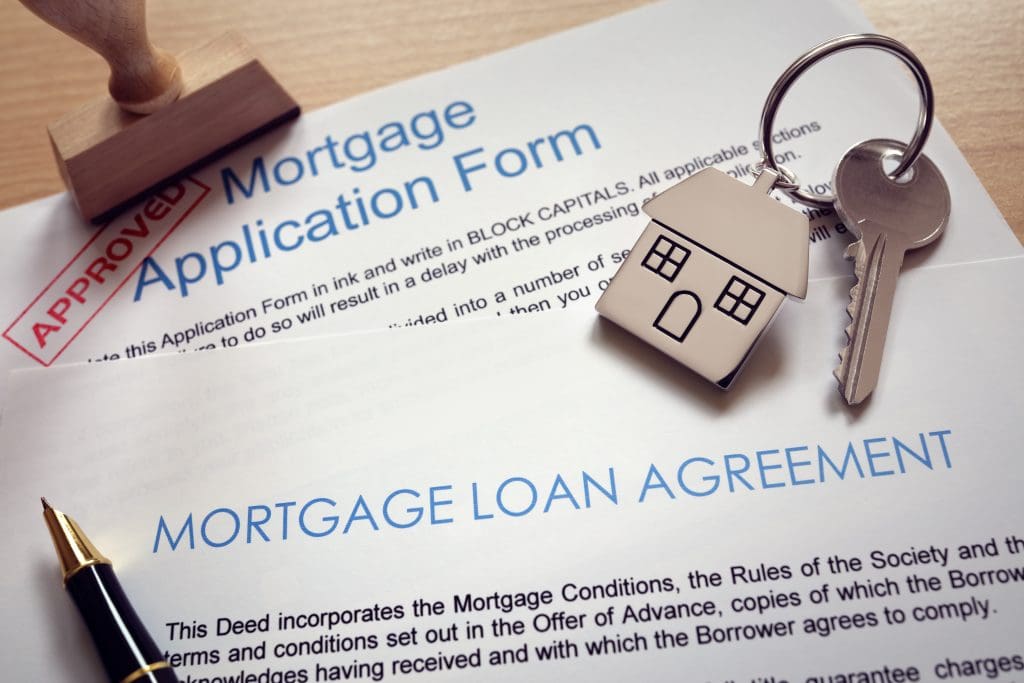 Mortgage loan agreement application with key on house shaped keyring - Applying for a Mortgage loan
