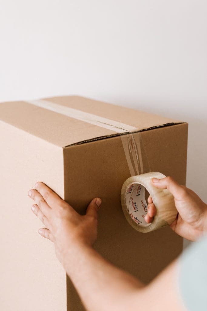 Man taping a moving box