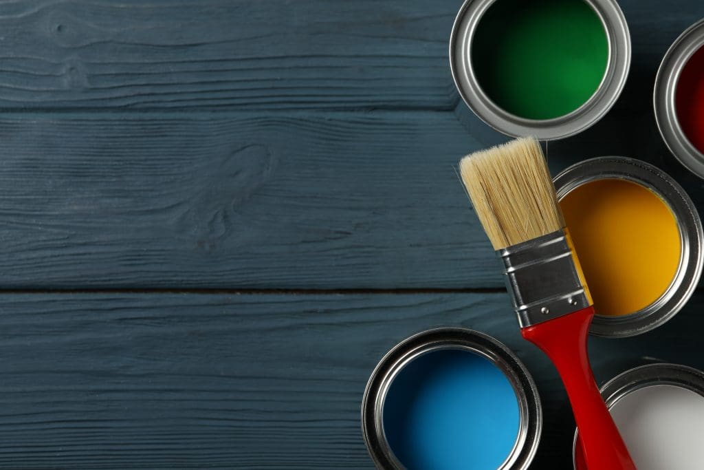 Paint cans and brush on wooden background.  Part of 7 pre-sale upgrades that won't break the bank.