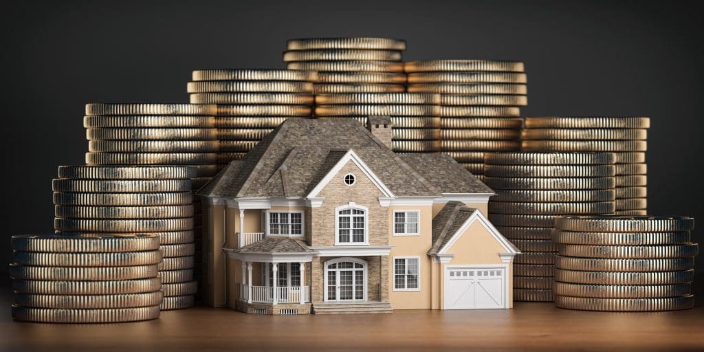 Real estate investments and mortgage concept. House and stack of coins. Saving money for buy a house 