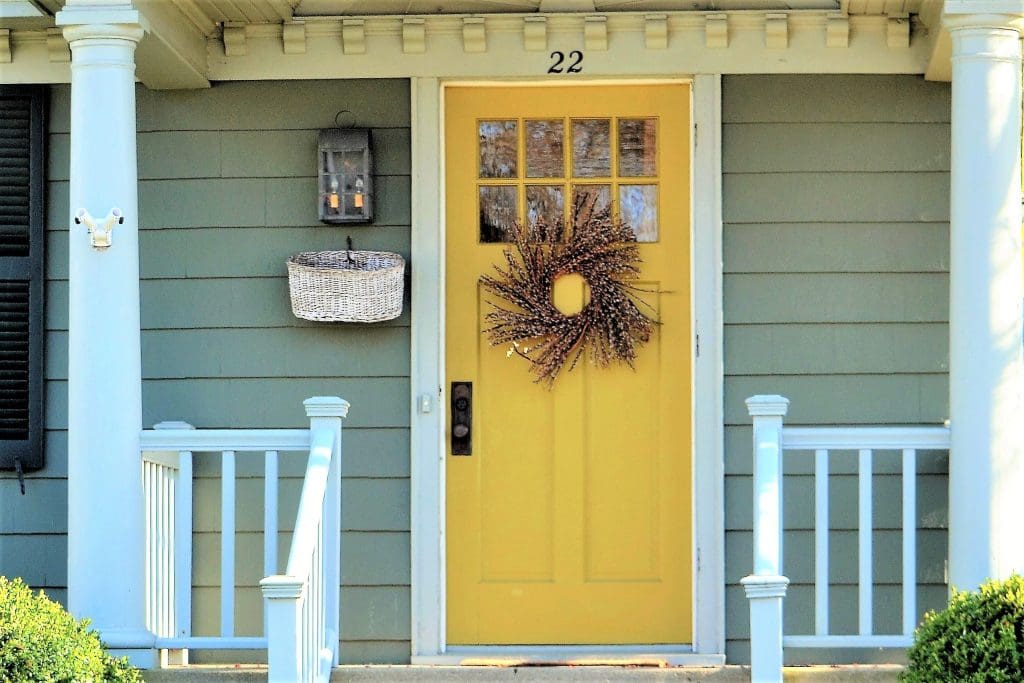 Yellow painted front door, front porch.