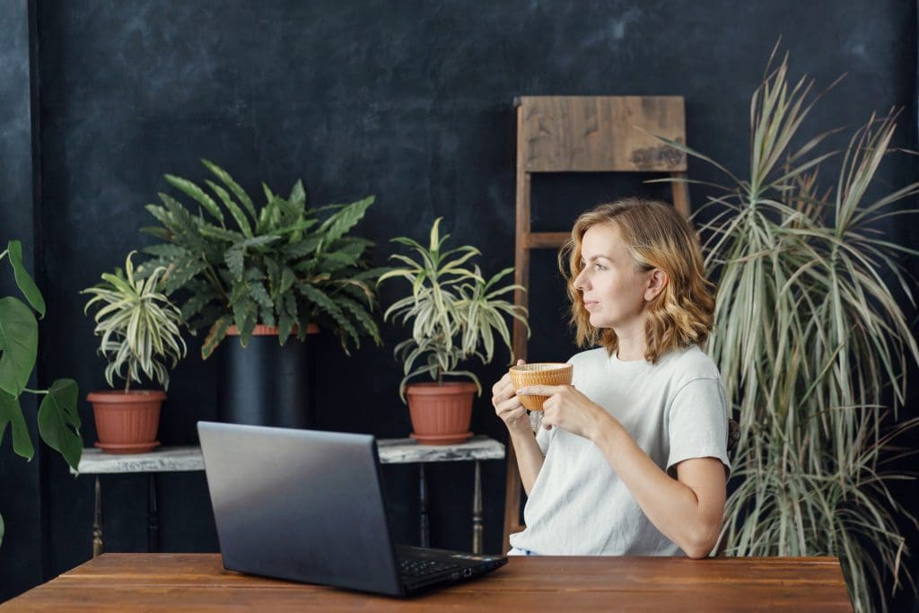 woman drinking coffee, looking out the window