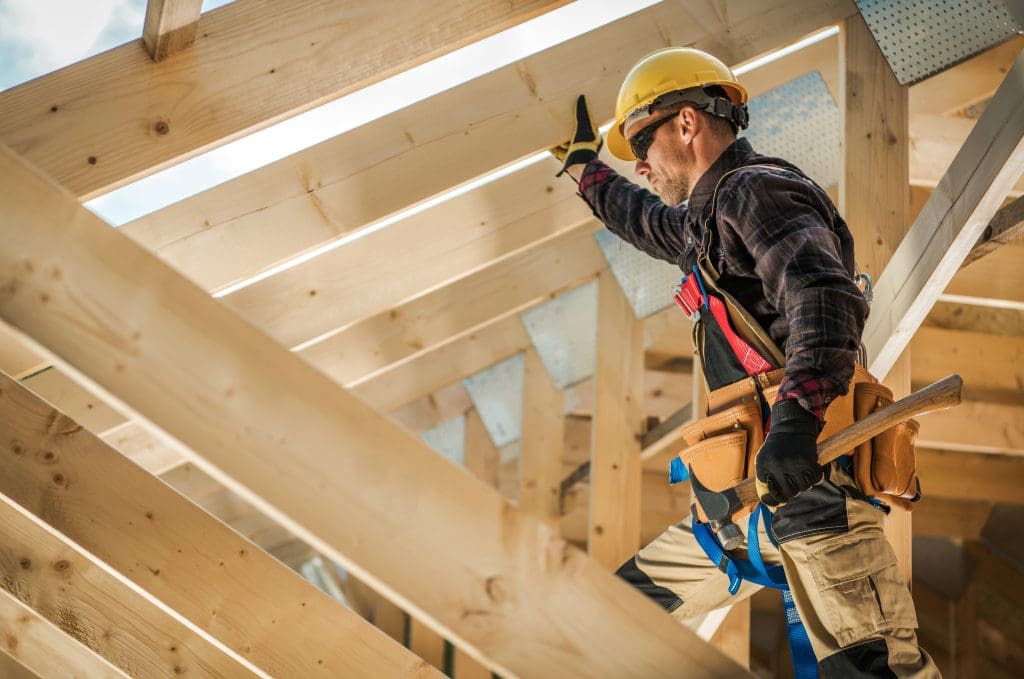 Construction Worker on Duty. Wooden House Frame. Tips for finding the right contractor