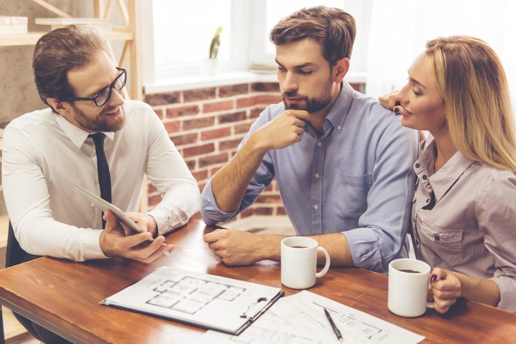 couple speaking to real estate agent