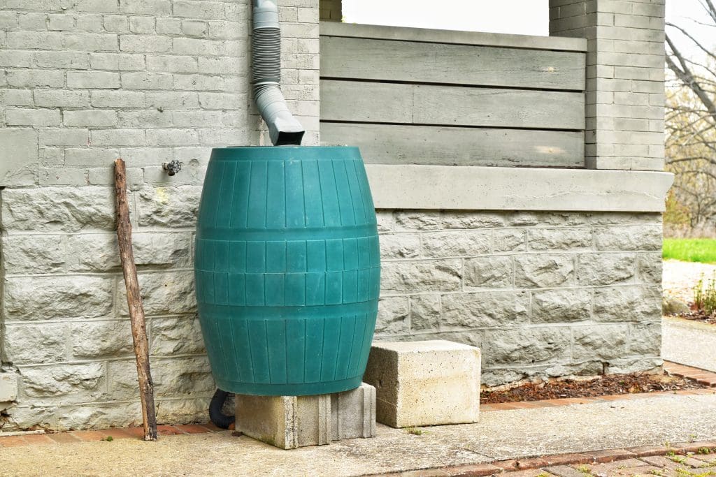 7 Ways to Reduce Your Carbon Footprint at Home.  Concept of rain barrels